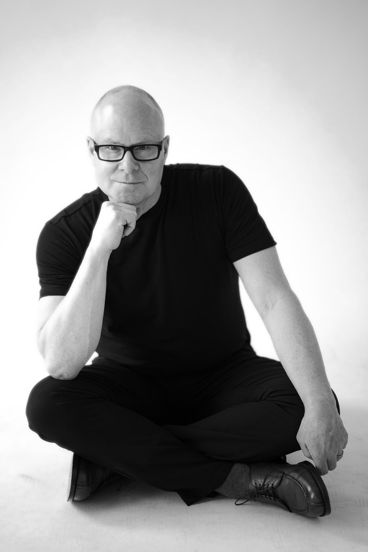 Colin Johnson, seated on the studio floor